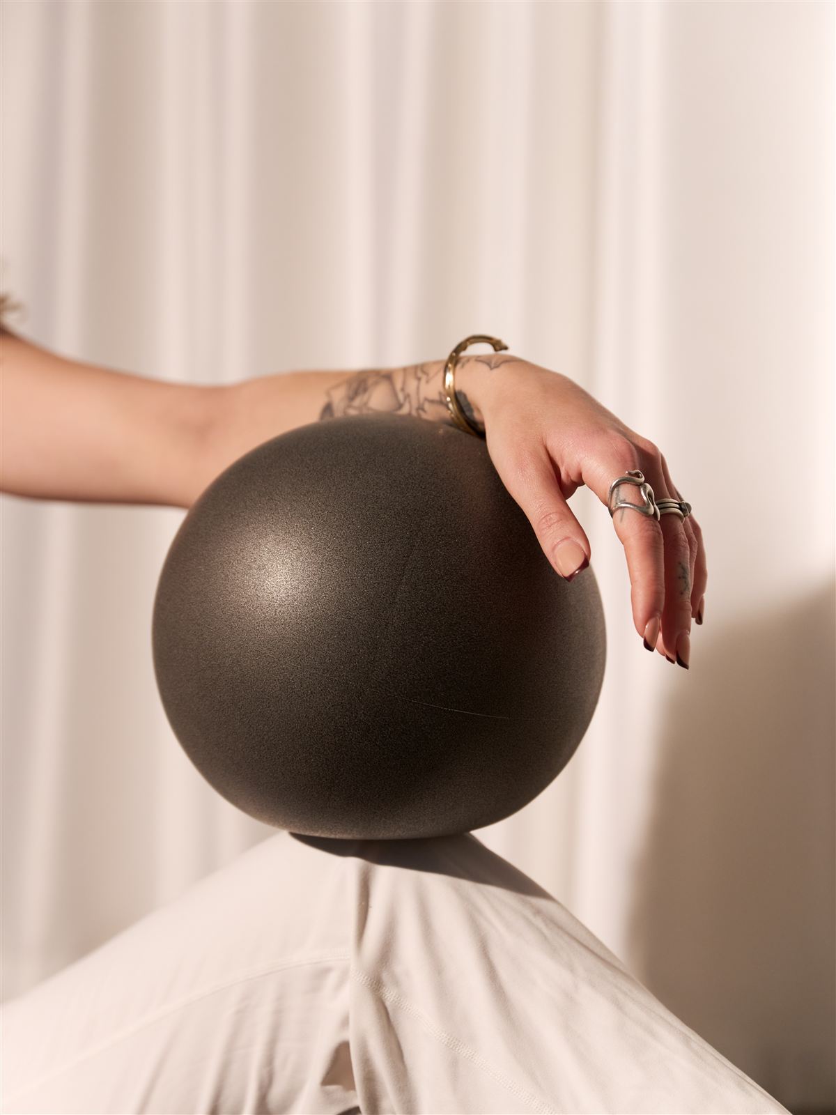 Detail shot of a hand resting on a Pilates ball